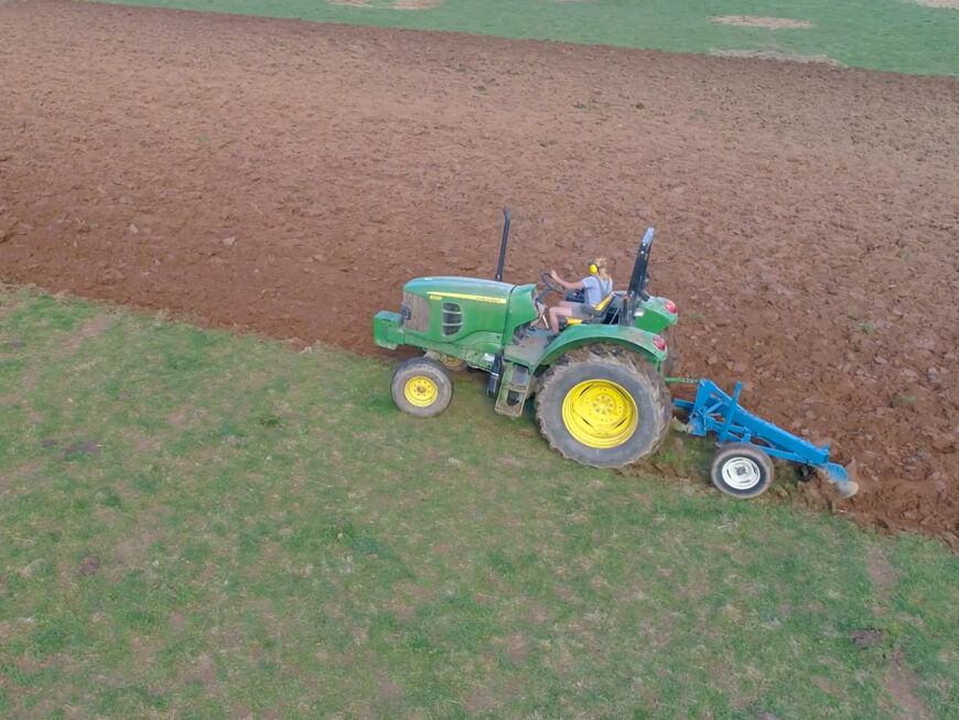 student driving a tractor