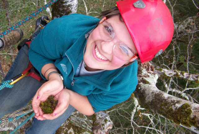Student collecting moss from a tree