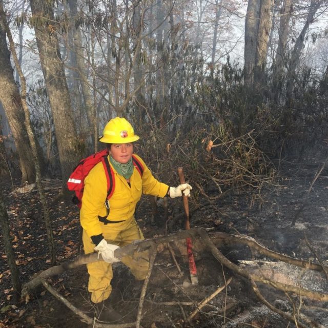 Junior Melina Lozano works on a fire off Bee Tree Road in Swannanoa last November. 