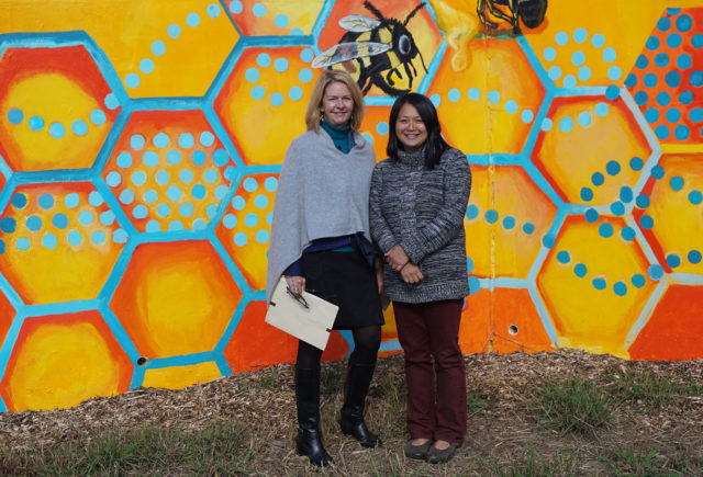 Lynn Morton and Lara Nguyen in front of mural