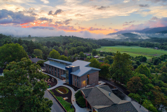 An aerial view of Myron Boon Hall with the backdrop of the swannanoa valley.