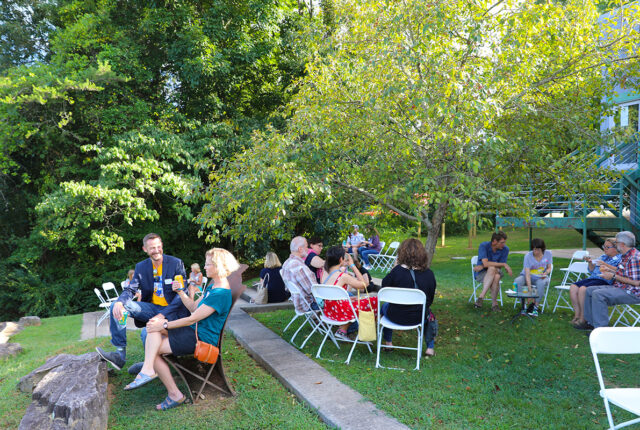 Parents gather at tables and chat at a family weekend event.